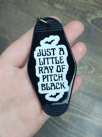 "Just A Little Ray Of Pitch Black" Retro Motel Keychain